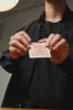 Marked playing card back held close to camera